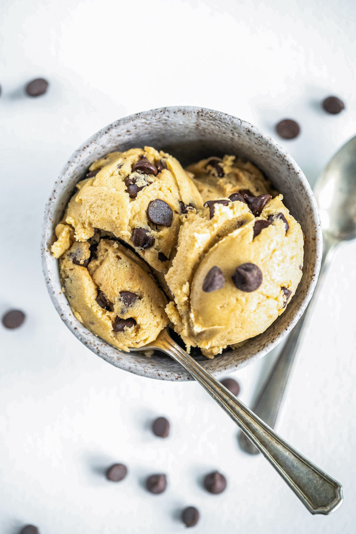An overhead picture of the finished Chocolate Chip Edible Cookie Dough in a bowl with spoons.