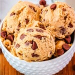 Three scoops of cookie dough in a white bowl.