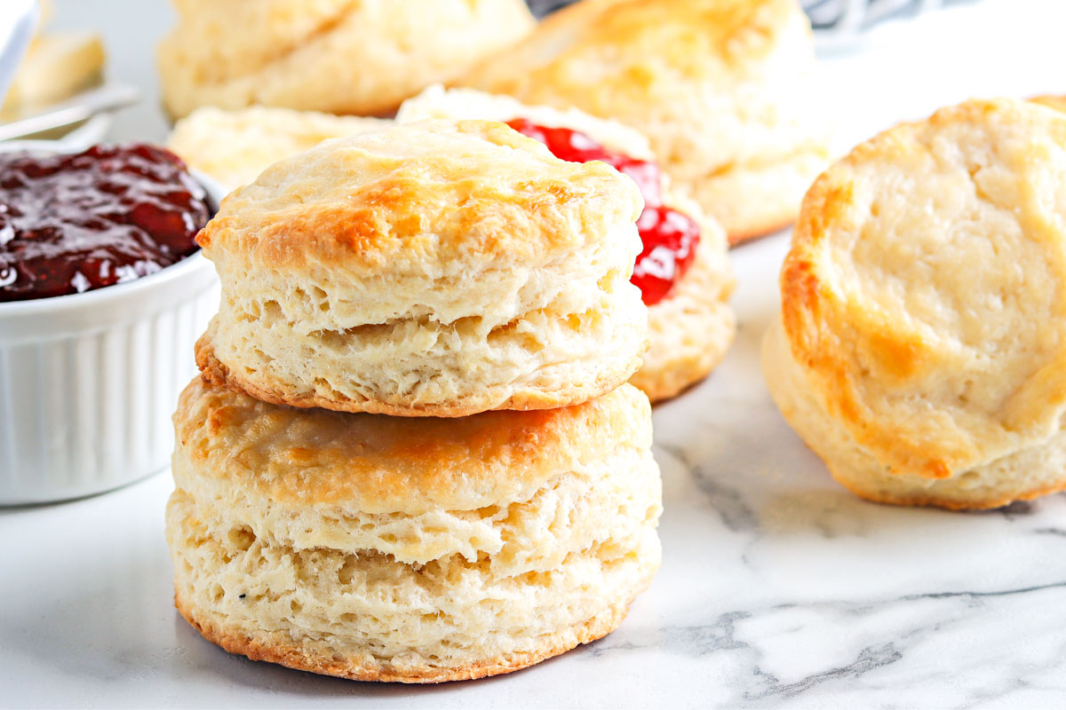 Two old fashioned buttermilk biscuits stacked on top of each other.