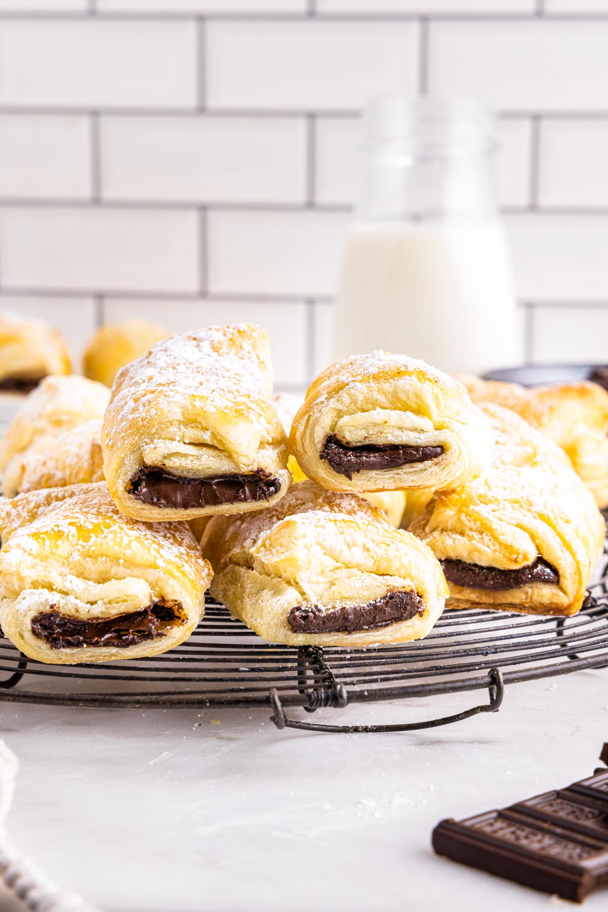 The finished Puff Pastry Chocolate Croissants on a wire rack.