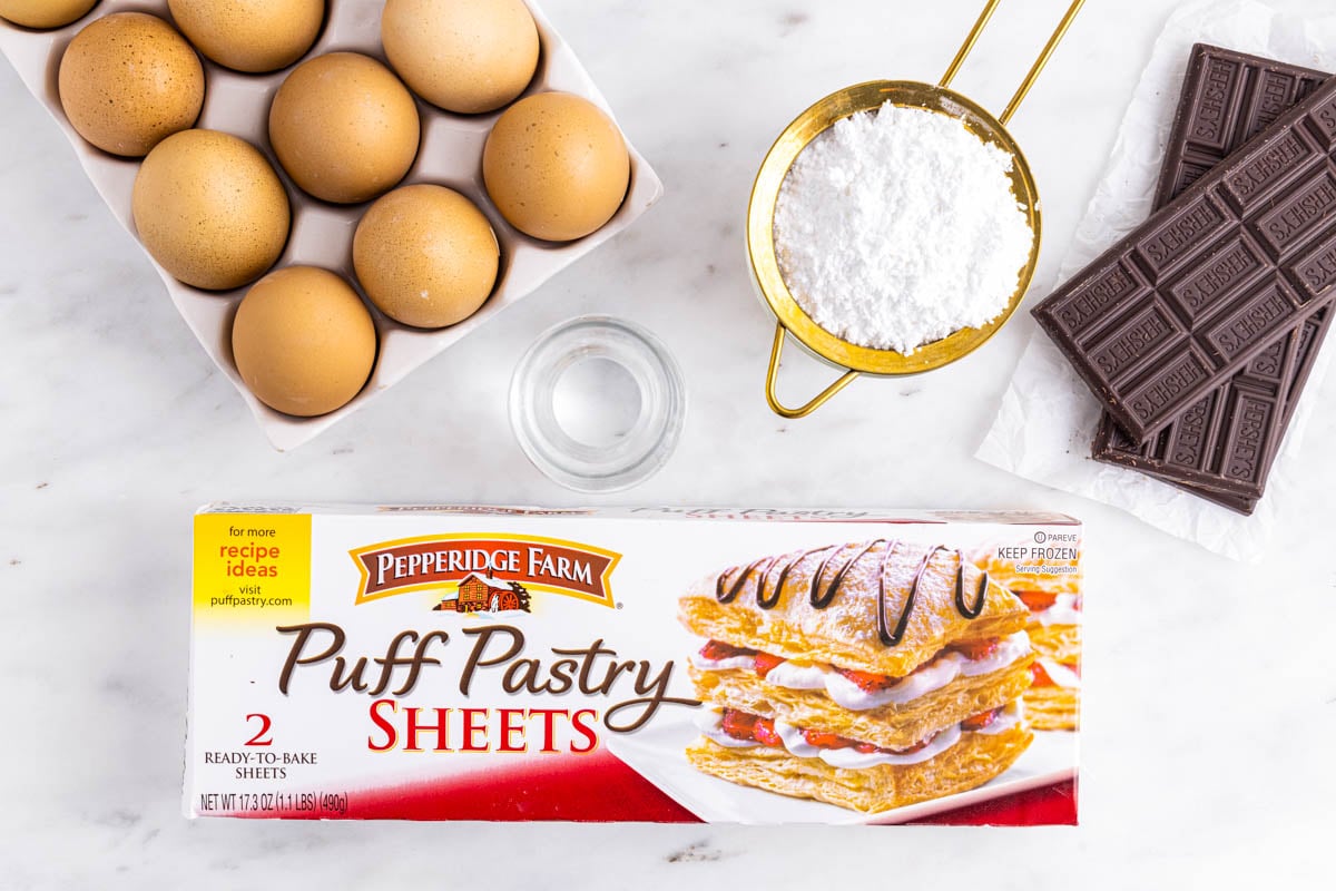 An overhead picture of all of the ingredients needed to make this Puff Pastry Chocolate Croissants recipe.