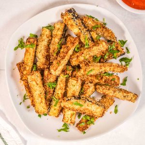 An overhead picture of a plateful of eggplant fries made in an air fryer.
