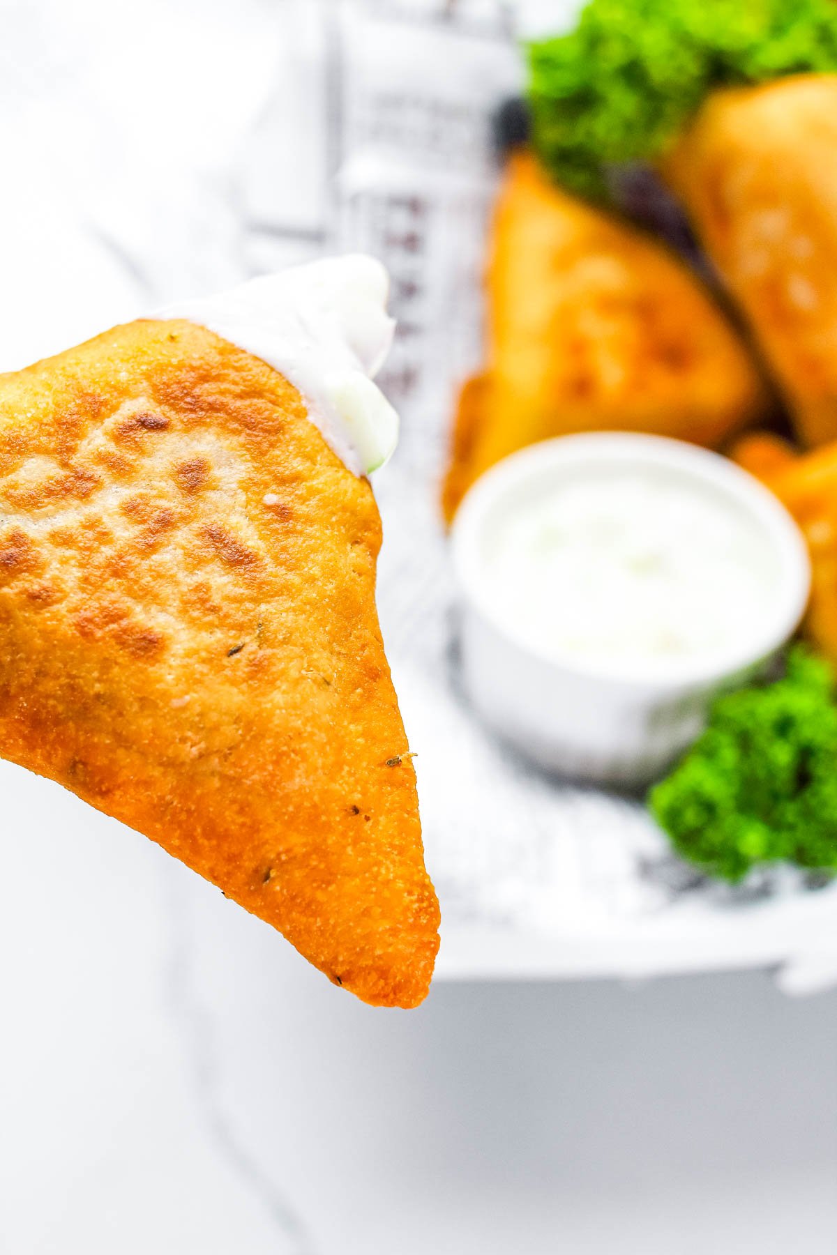 A close ip picture of a finished Vegetable Samosa so you can see the crispy texture.