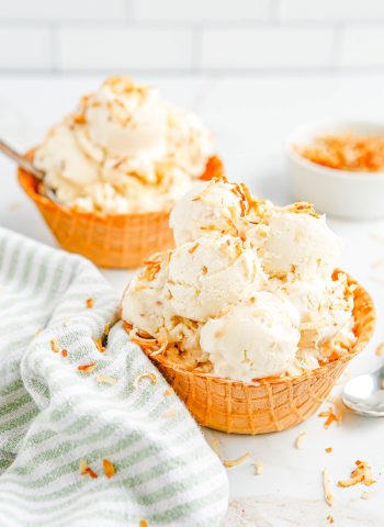 Two waffle bowls full of all scoops of the finished Toasted Coconut Ice Cream.