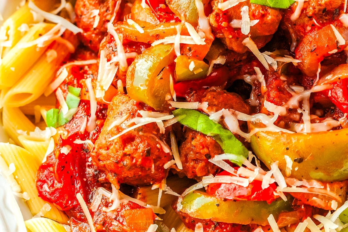 Pasta with Peppers, Onion, and Sausage in a serving dish and garnished with mozzarella.