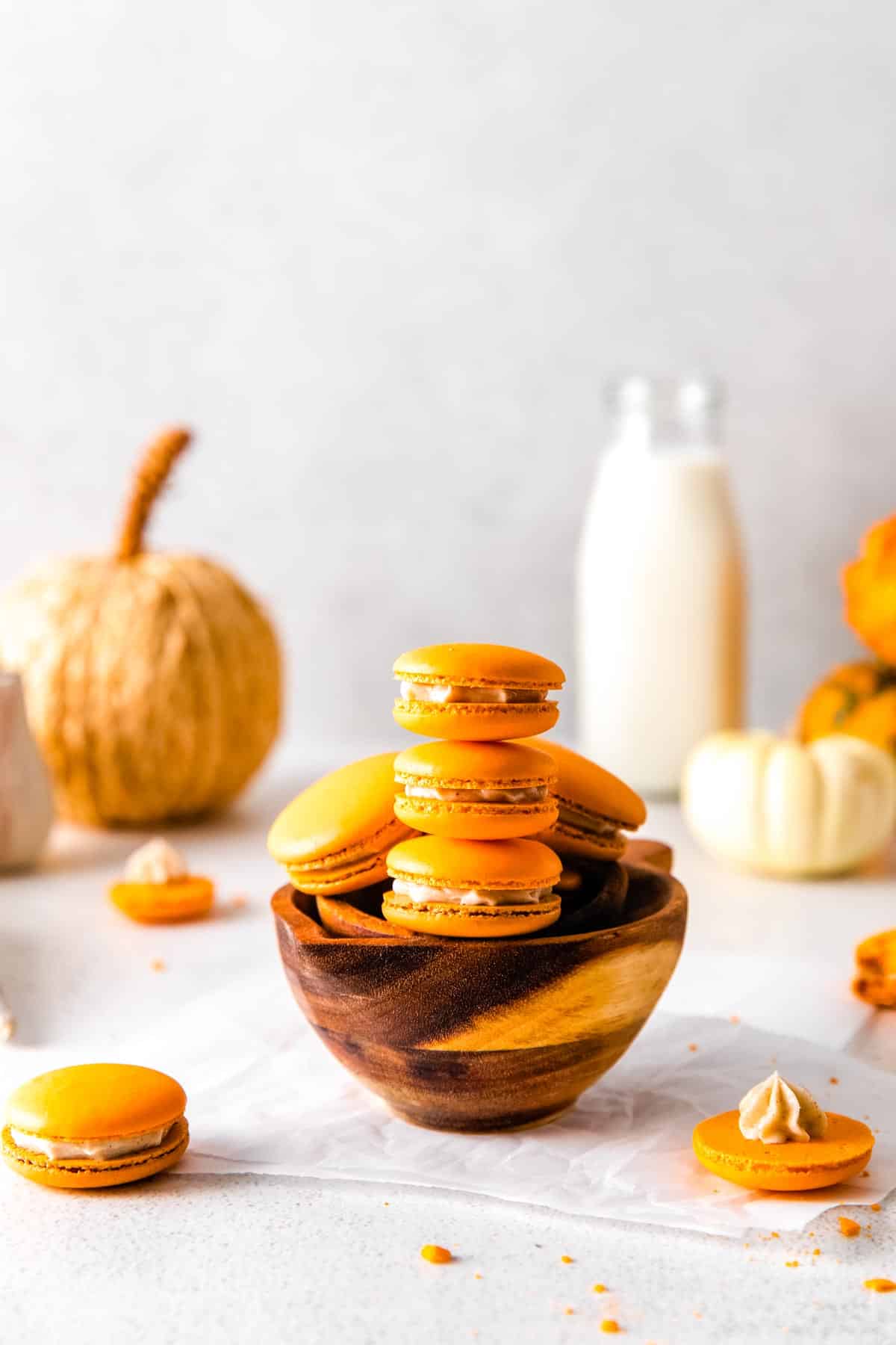 Three Pumpkin Spice Macarons stacked on top of each other.
