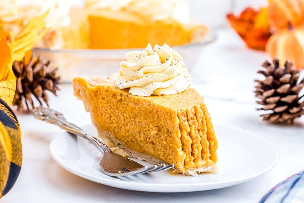 A piece of the chiffon pumpkin pie recipe on a white plate.