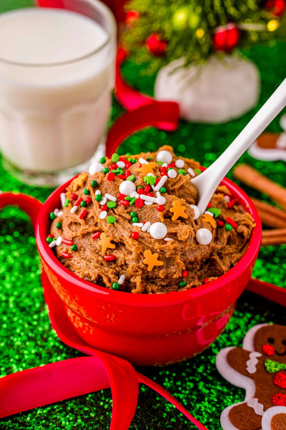 Th finished Gingerbread Edible Cookie Dough in a red bowl with a spoon.