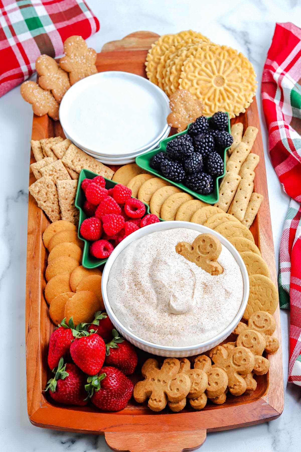 An overhead picture of the finished Eggnog Dessert Dip on a platter with cookies and fruit for dipping.