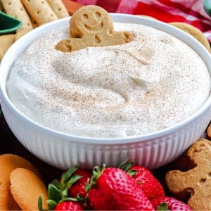 The finished Eggnog Dip recipe with dippers of ginger cookies and fruit all around on a platter.