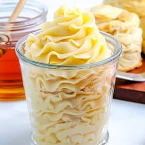 A close up picture of honey whipped butter recipe pipped into a glass jar.