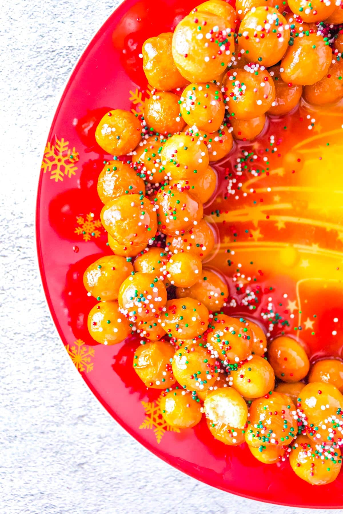 The finished Italian Struffoli on a plate and covered in sprinkles.