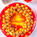 The finished Struffoli on a red plate.