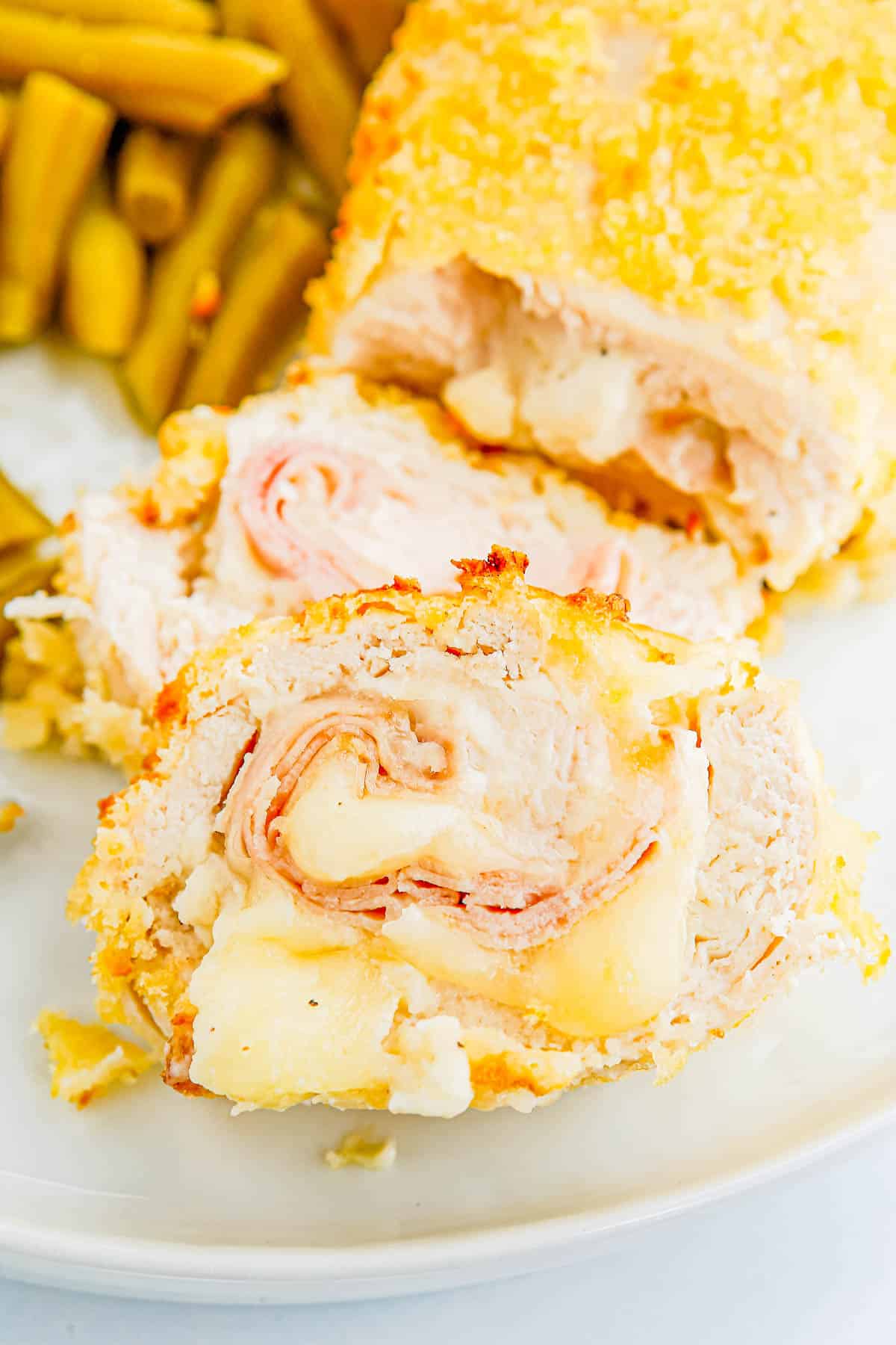 The finished Air Fryer Chicken Cordon Bleu recipe on a white dinner plate.