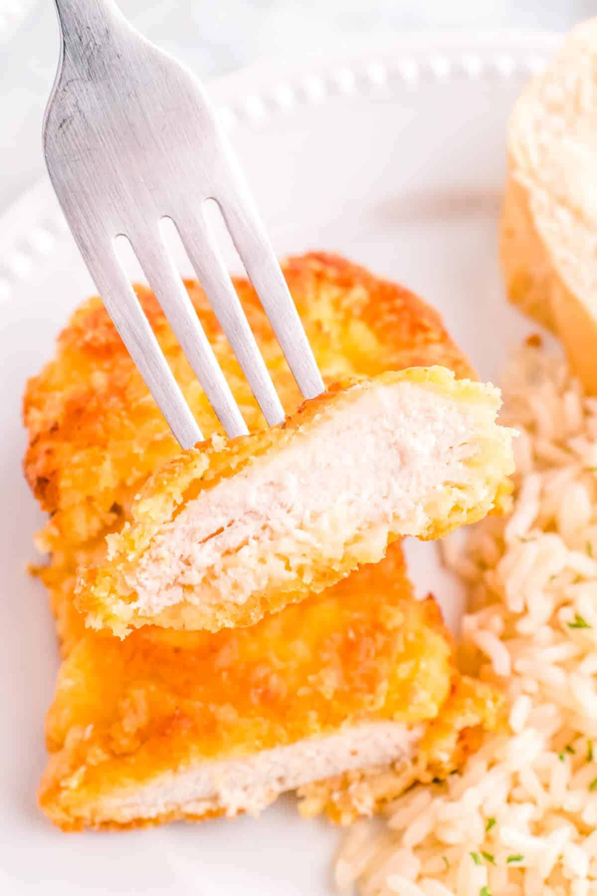 A look inside a Baked Breaded Chicken Recipe that has been cut into.