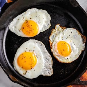 A close up picture of a fried egg in a skillet.
