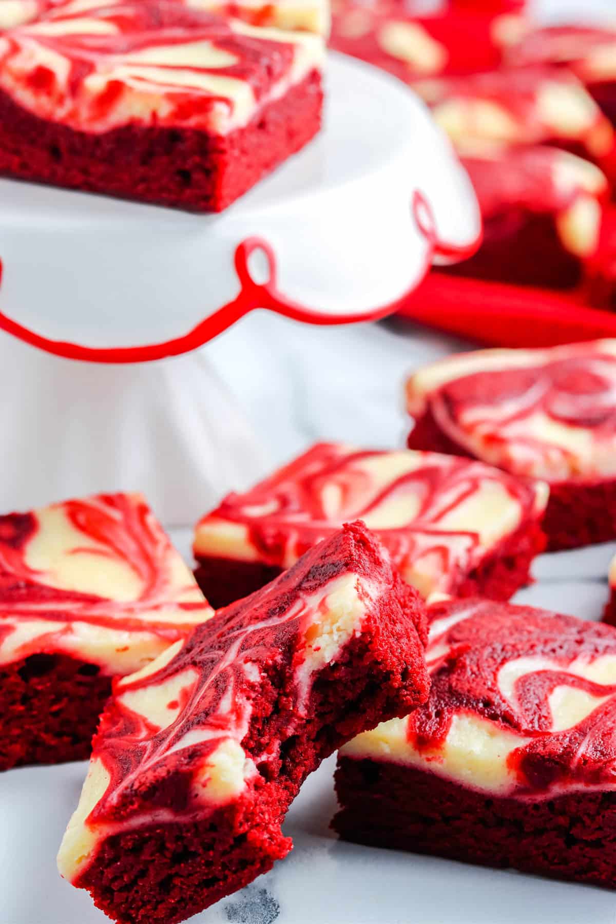 A close up picture of a Red Velvet Brownie with a bite taken out of it.