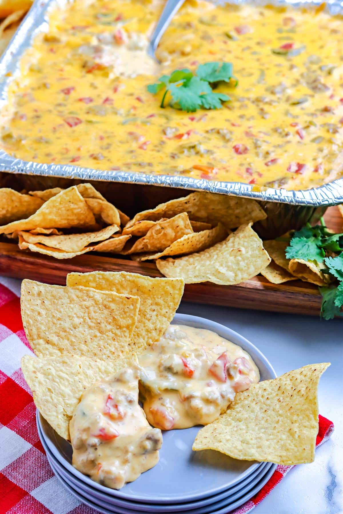 The finished Smoked Queso Recipe scooped out on a plate with chips.