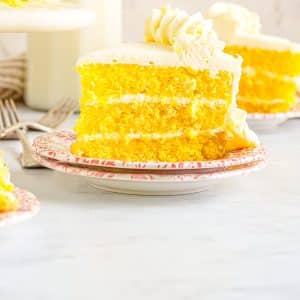A slice of Lemon Velvet Layer Cake on a dessert plate.