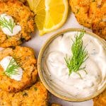 The finished Air Fryer Salmon Patties on a platter with dill dipping sauce