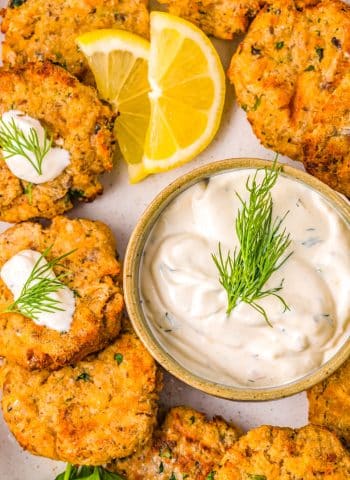 The finished Air Fryer Salmon Patties on a platter with dill dipping sauce