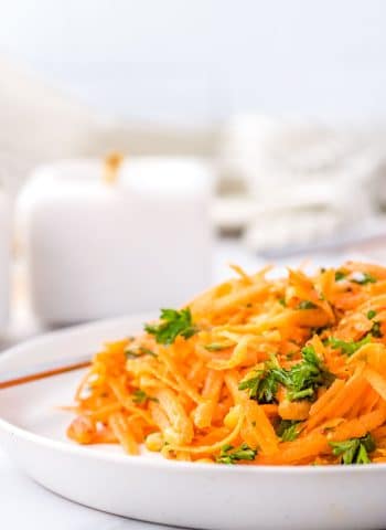 A close up picture of French Carrot Salad on a white plate.