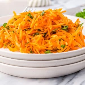 The finished French Carrot Salad recipe on a white serving plate.