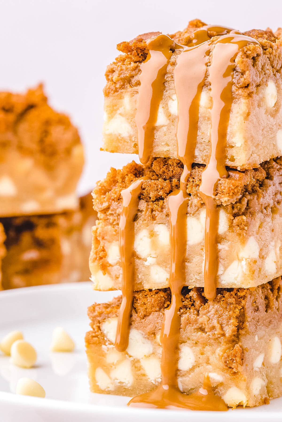 A close up picture of three Biscoff Blondie Bars stacked on top of each other.