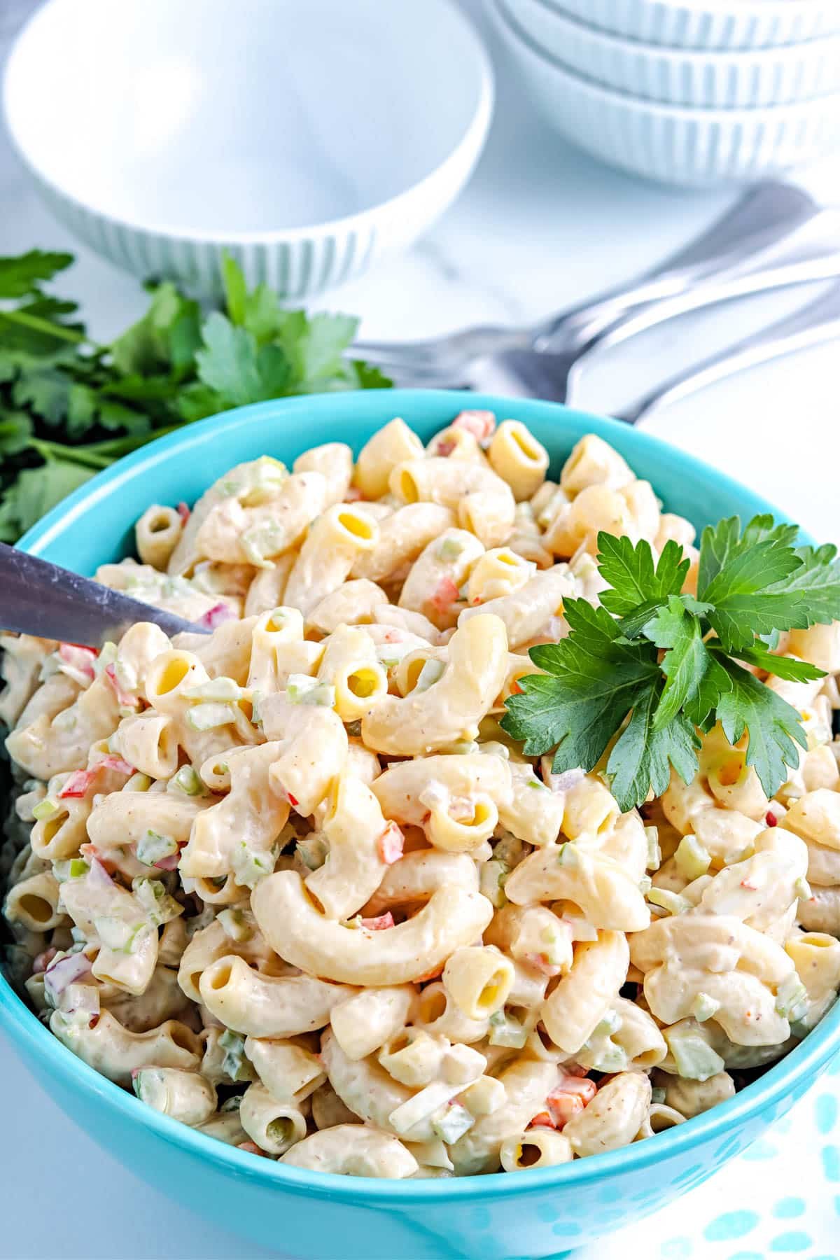 The finished Deli Style Macaroni Salad in a blue serving bowl.