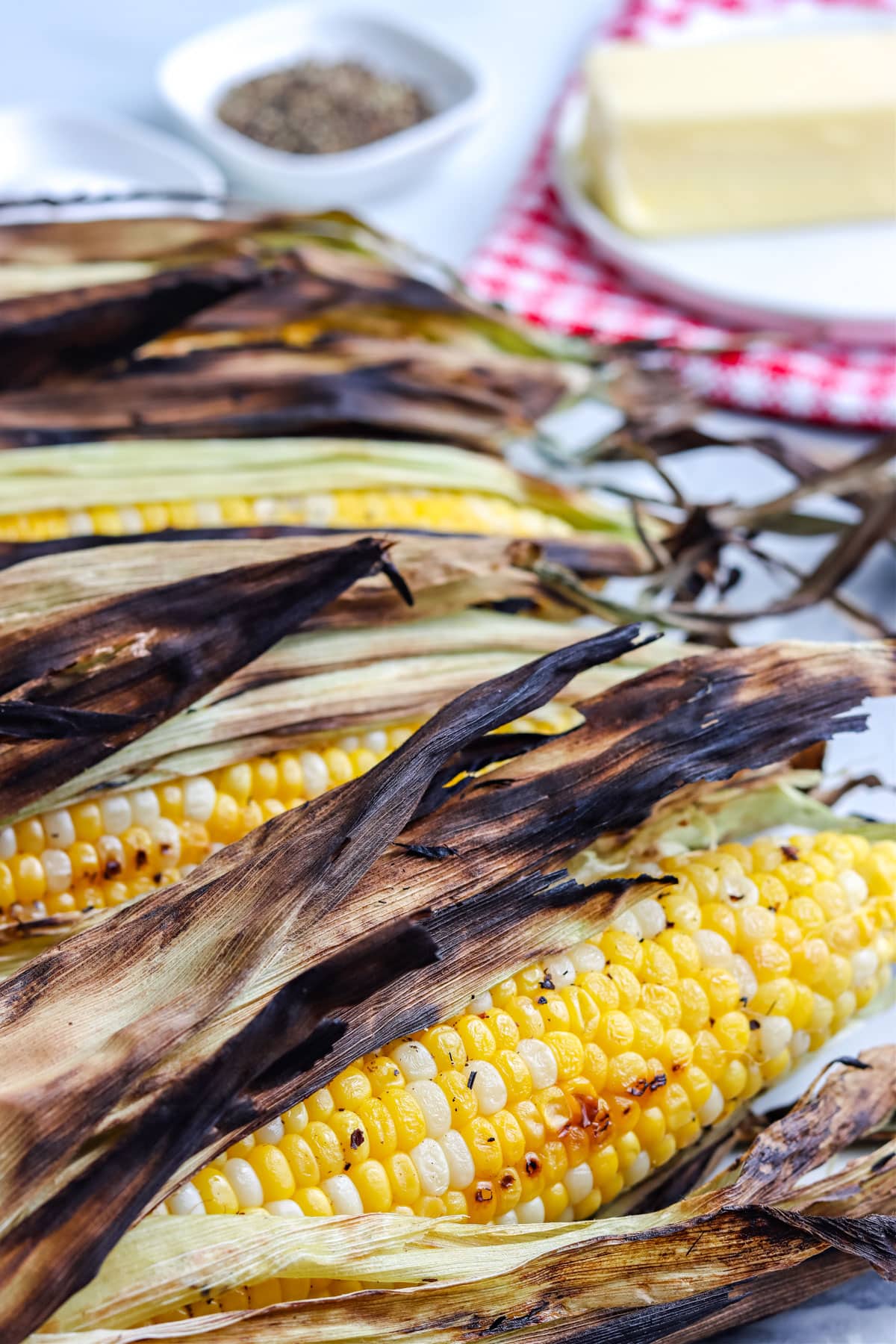 A close up picture of the finished Grilled Corn On The Cob In Husk.