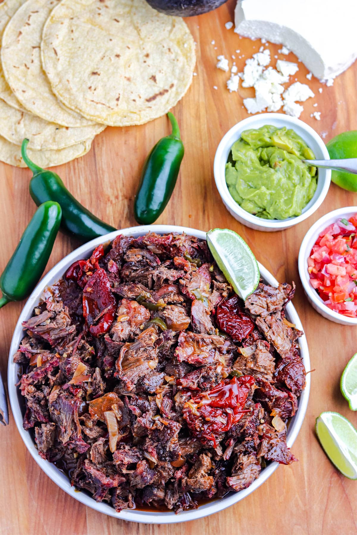 An overhead picture of smoked Barbacoa in a white serving bowl.