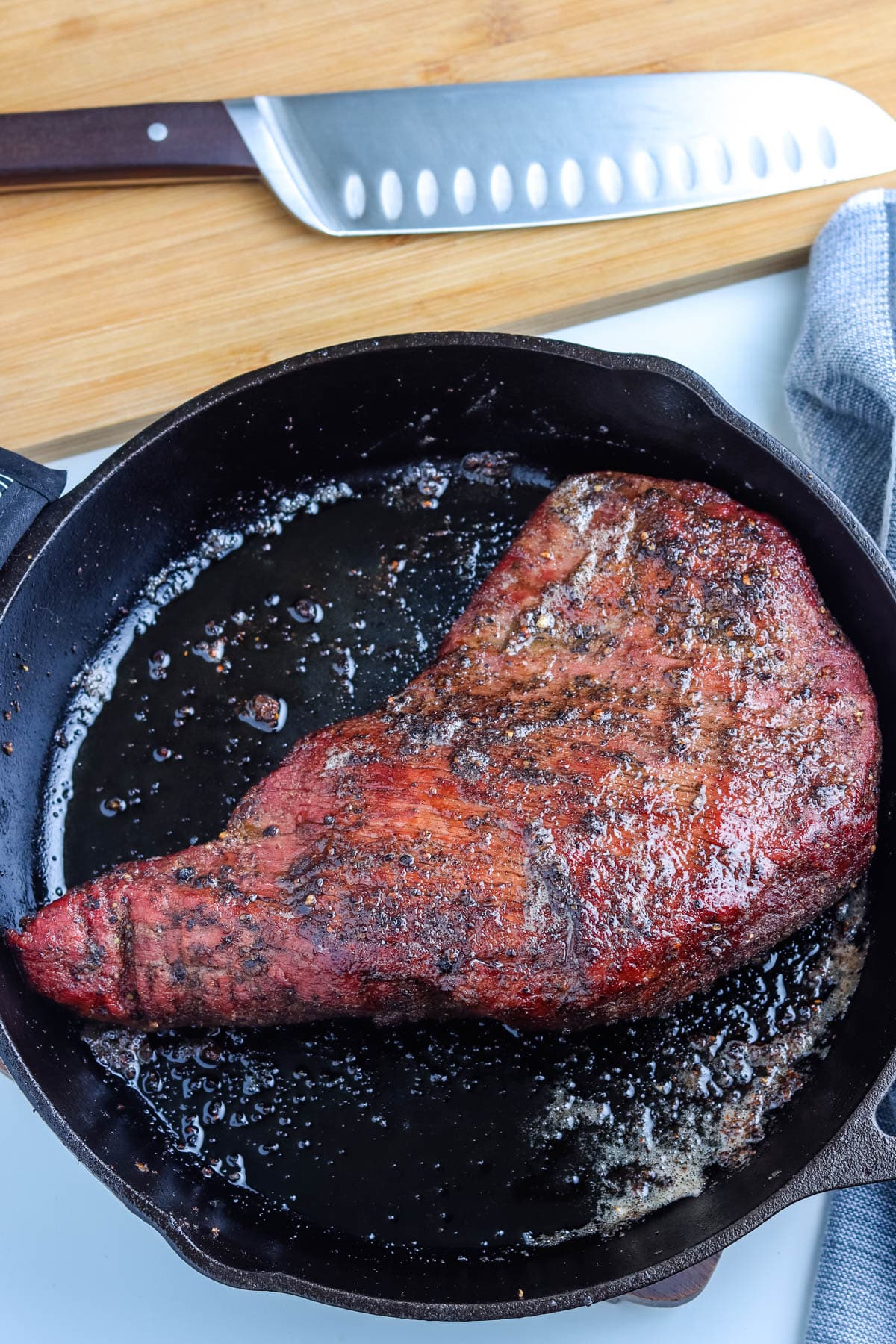 The finished Smoked Tri Tip recipe in a cast iron skillet.