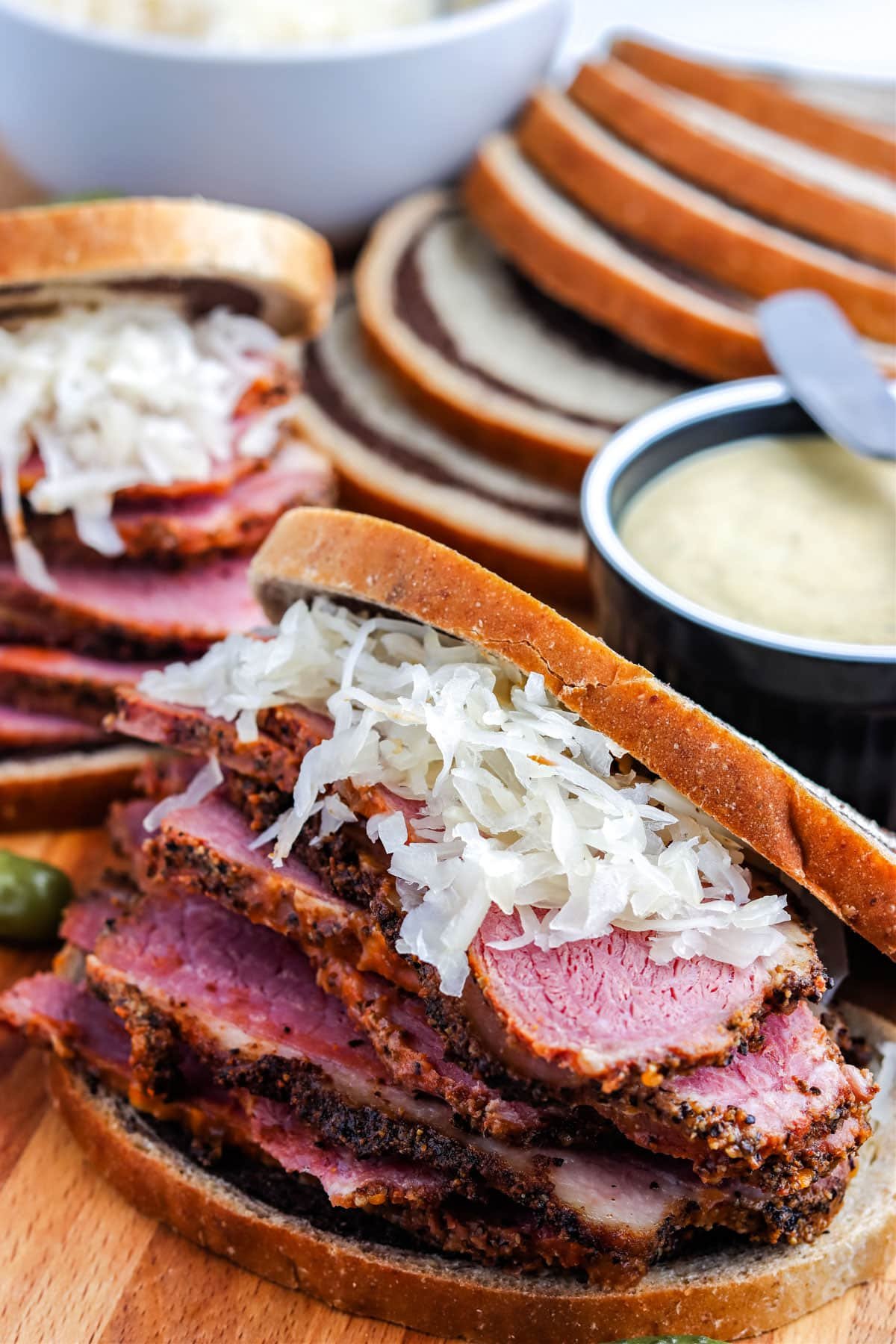 The finished Smoked Pastrami stacked high on marble rye bread. 