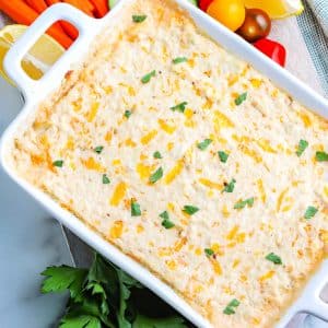 A close up picture of the finished Hot Crab Dip Recipe in a baking dish.