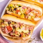 Two chopped Italian subs on a white plate.