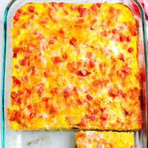 An overhead of ham and potato breakfast casserole in a pyrex dish.