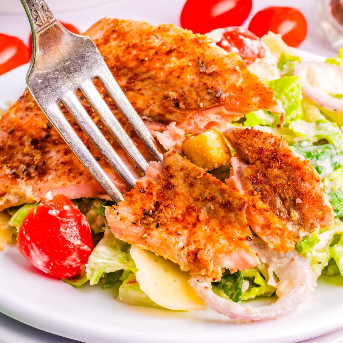 A fork digging into the salad.