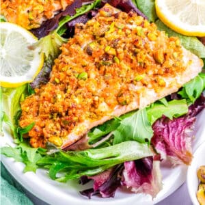 Salmon on a plate with lemon slices.