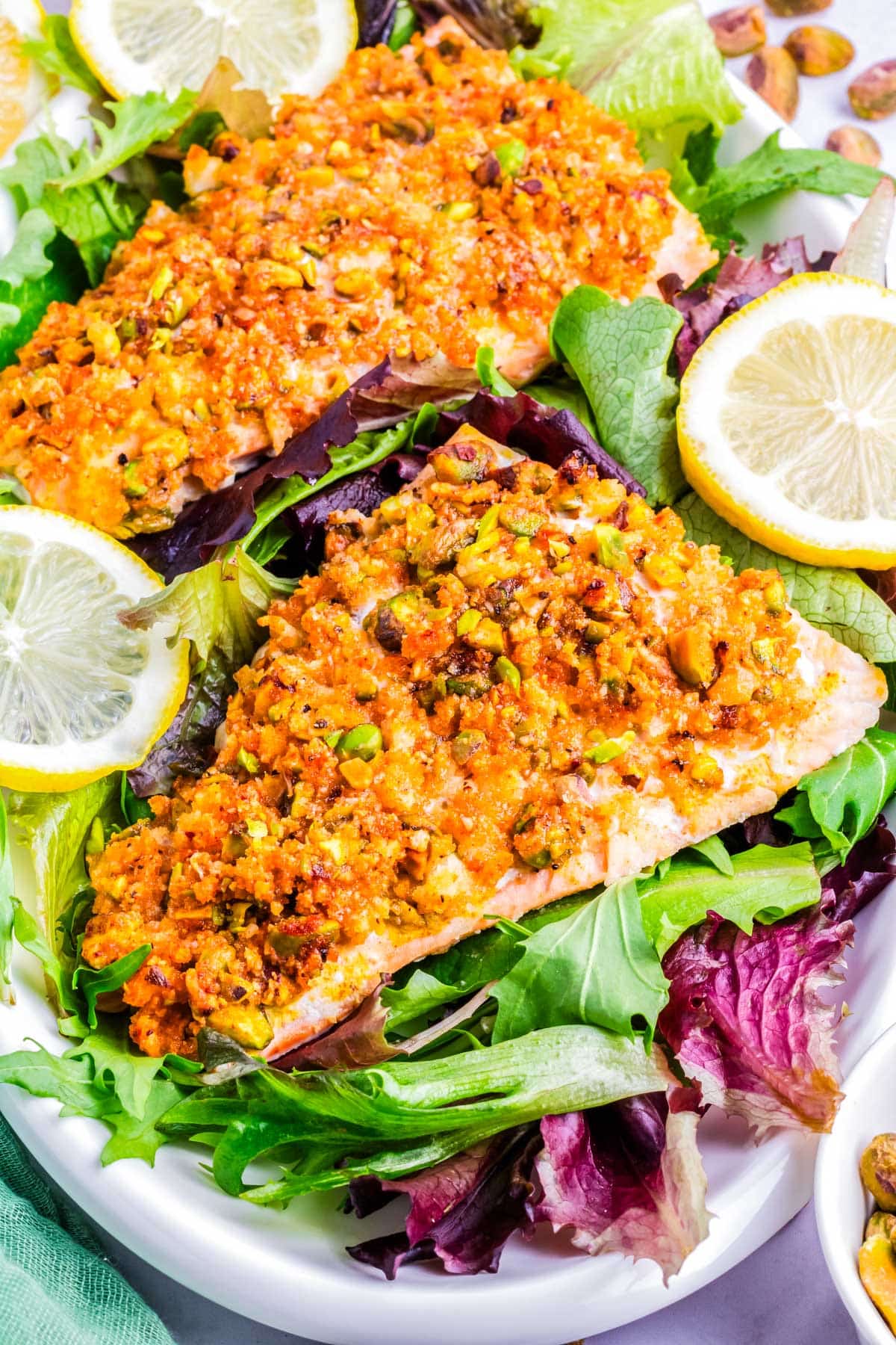Pistachio Salmon on a bed of salad greens.