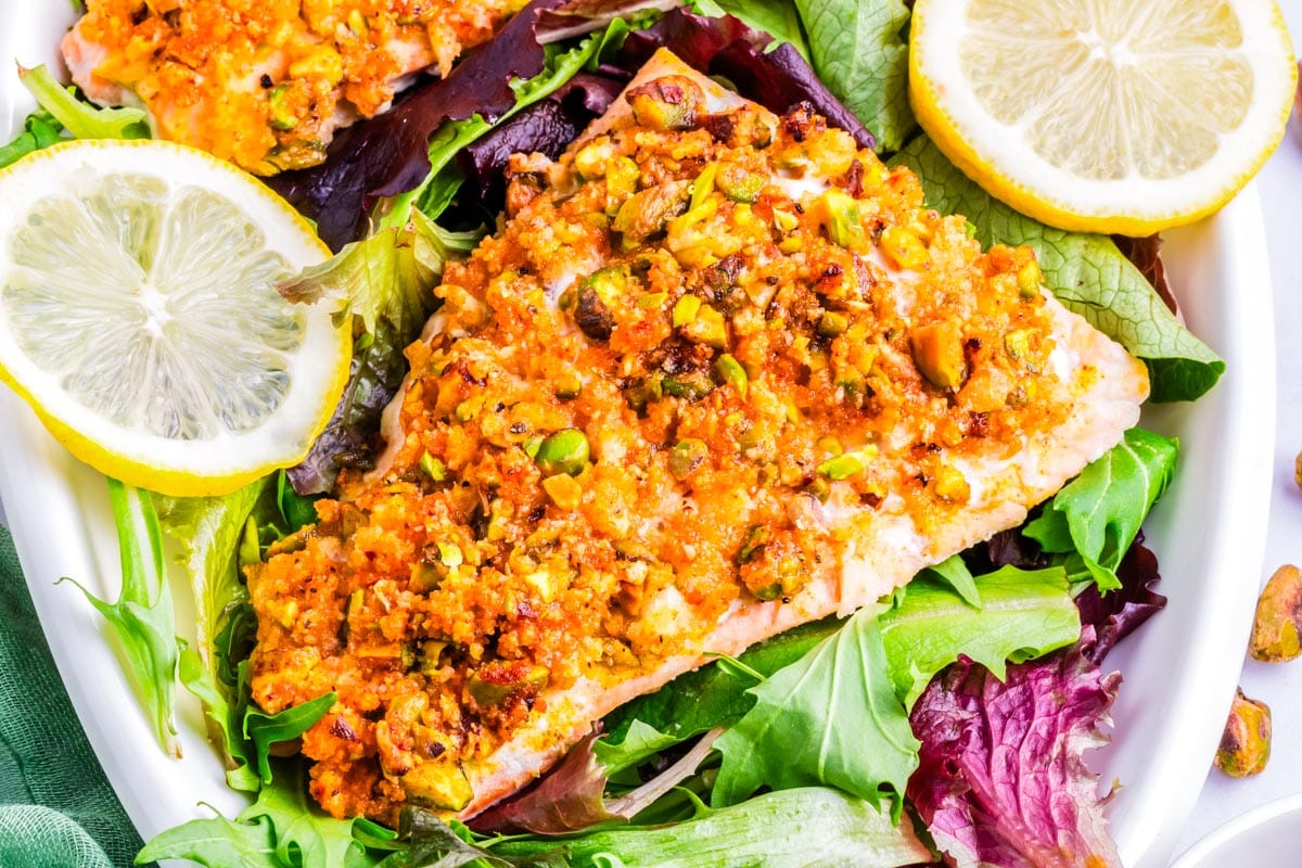 Pistachio crusted salmon on salad greens.