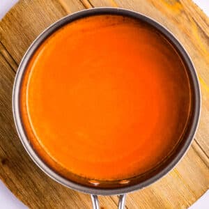Homemade Buffalo sauce in a saucepan.