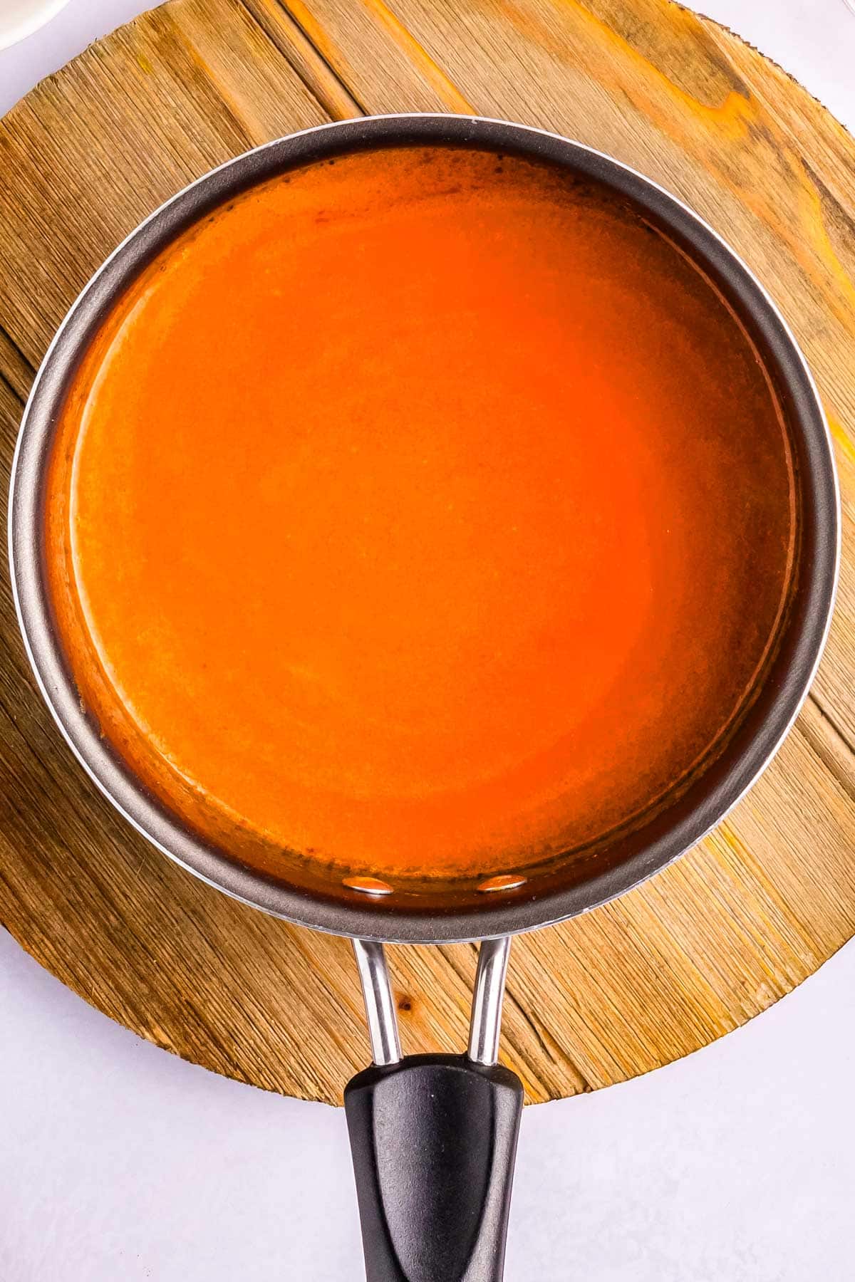 Buffalo Sauce in a saucepan.