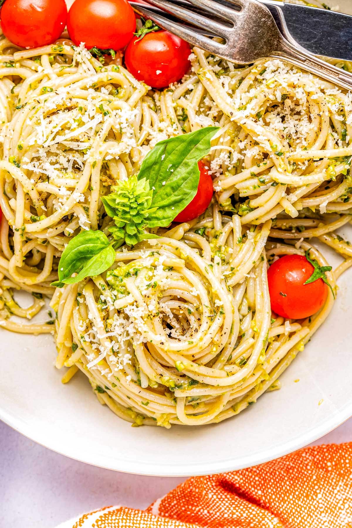 Pasta tossed with the pesto on a white plate.