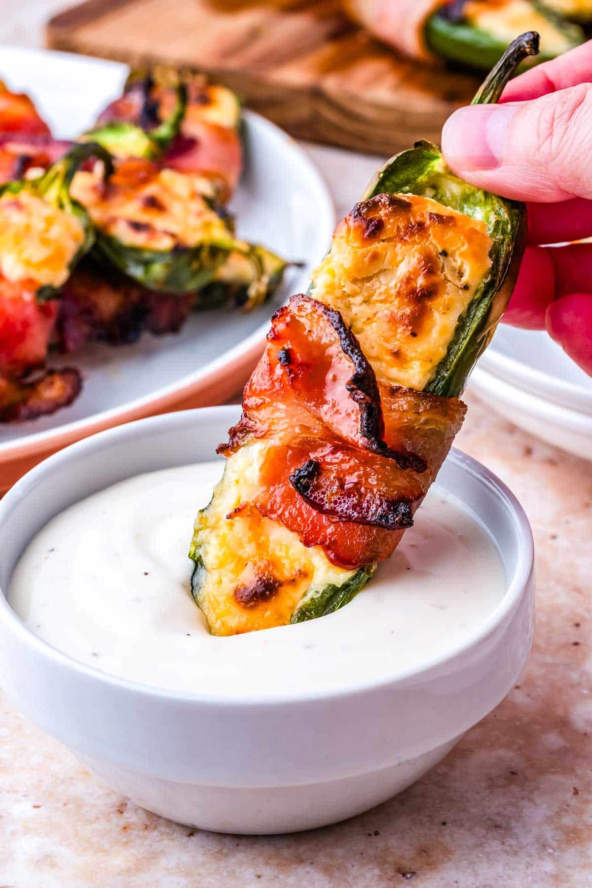 An Air Fryer Jalapeno Popper dipped into ranch dressing.