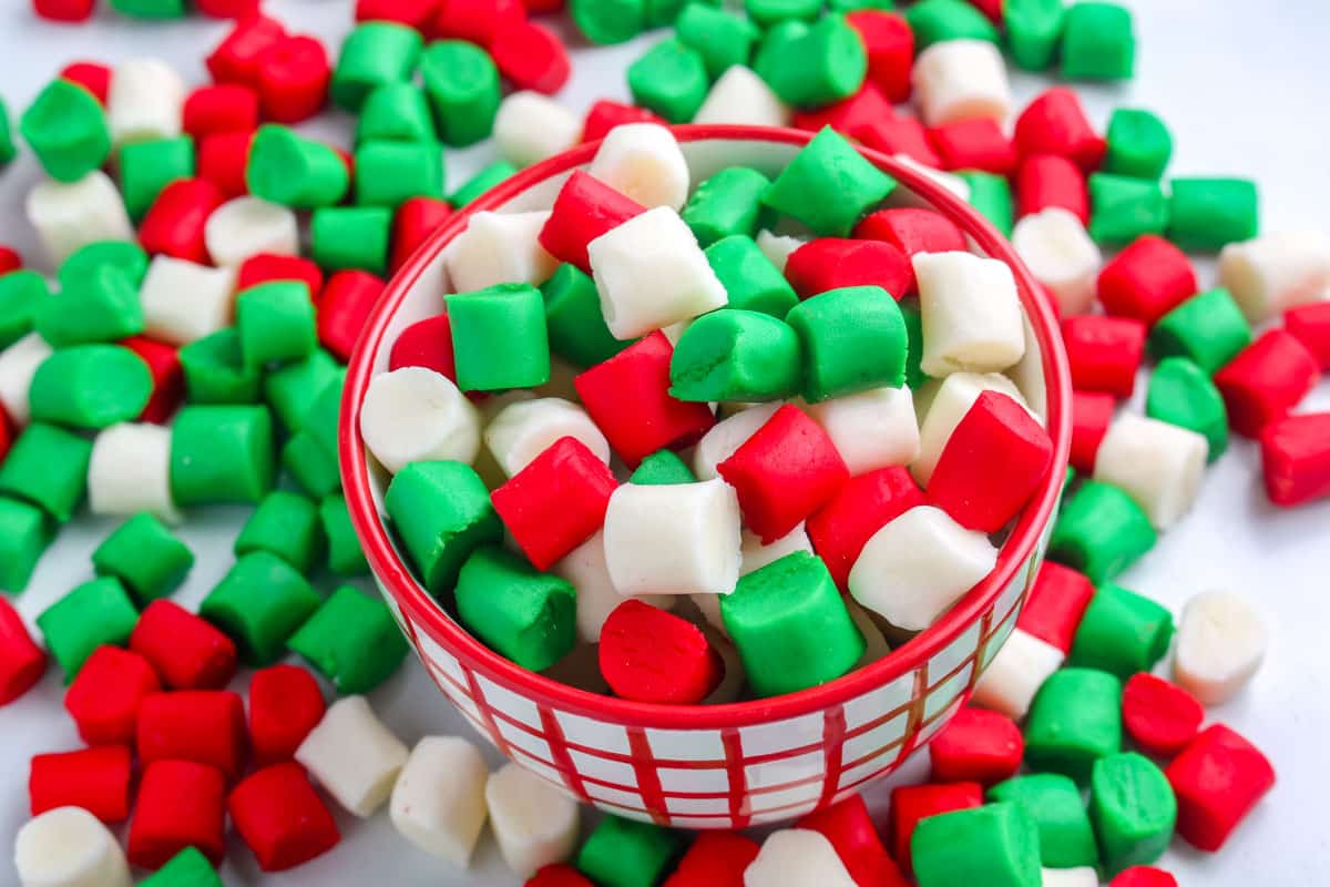 Christmas butter mints in a red and white candy dish.