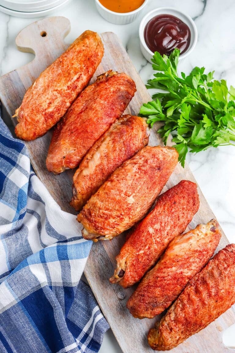 Smoked turkey wings on a white platter.