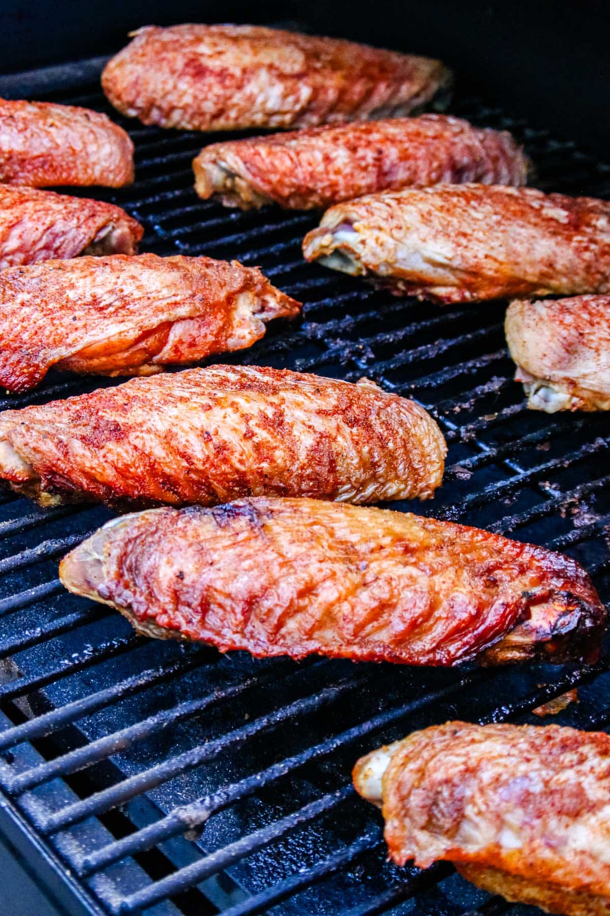 The finished Smoked Turkey Wings on the grill grates of a Traeger smoker.
