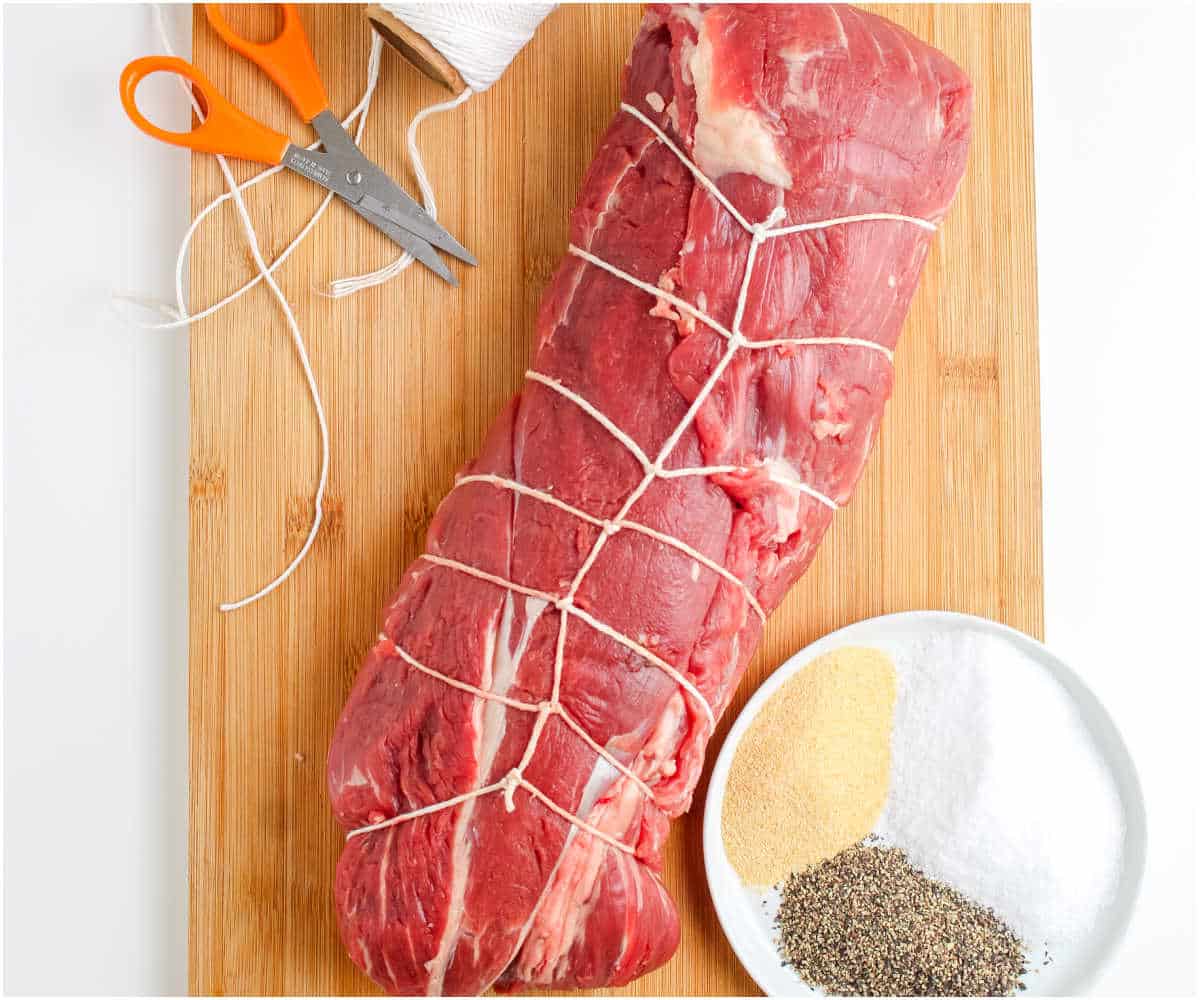 The beef tenderloing wrapped with butcher twine.