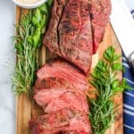 A Smoked Beef Tenderloin on a wooden cutting board.