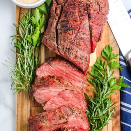 A Smoked Beef Tenderloin on a wooden cutting board.